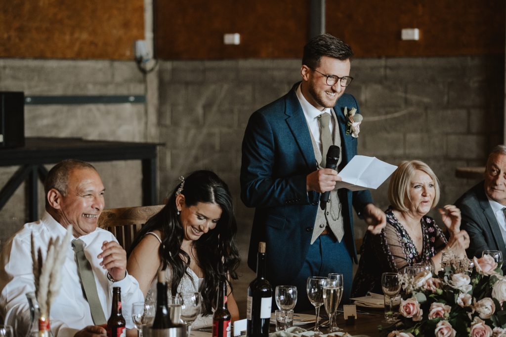 Speeches in the grain store. The Barns at Lodge Farm, wedding photographer.