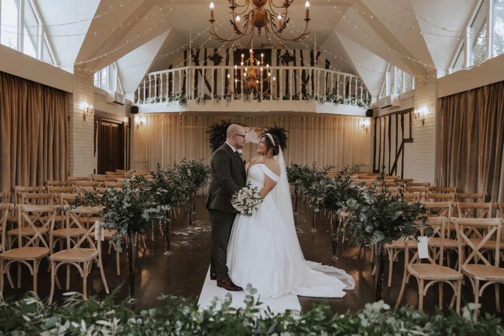The couple in the ceremony barn at Seckford hall, Suffolk