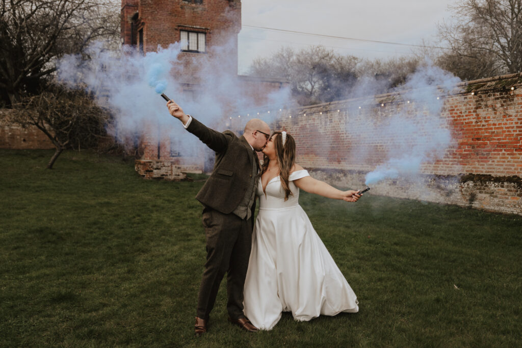 Couple using smoke flares at Suffolk wedding venue Seckford Hall