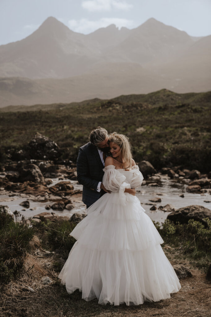 A couple having eloped on the Isle of Skye having their elopement photos at The Fairy Pools