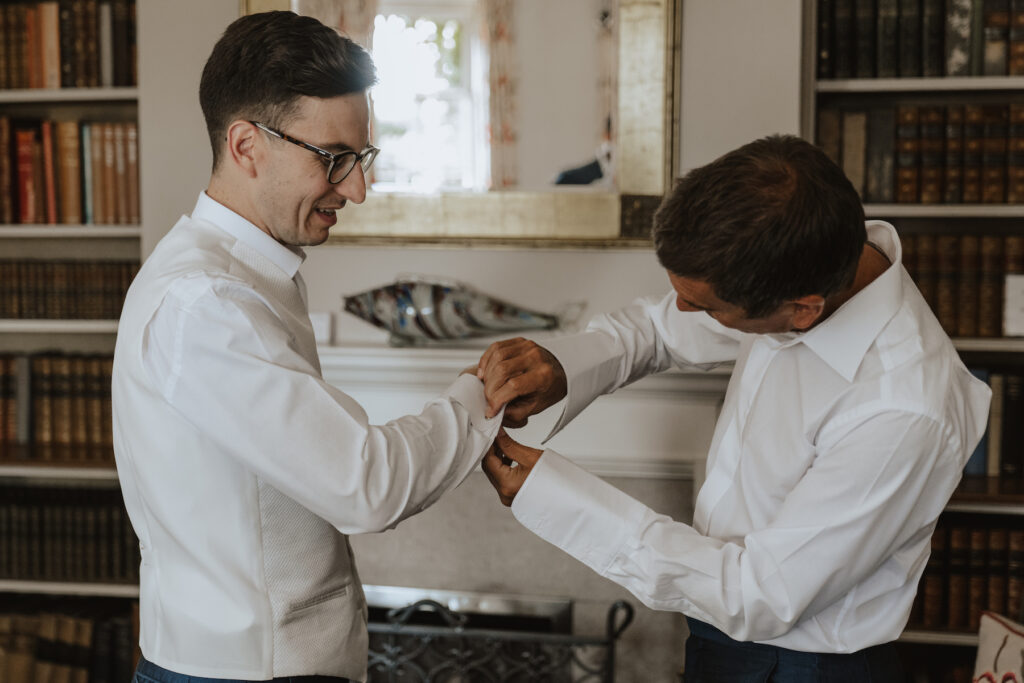 Suffolk wedding photographer capturing grooms prep at Butley Priory