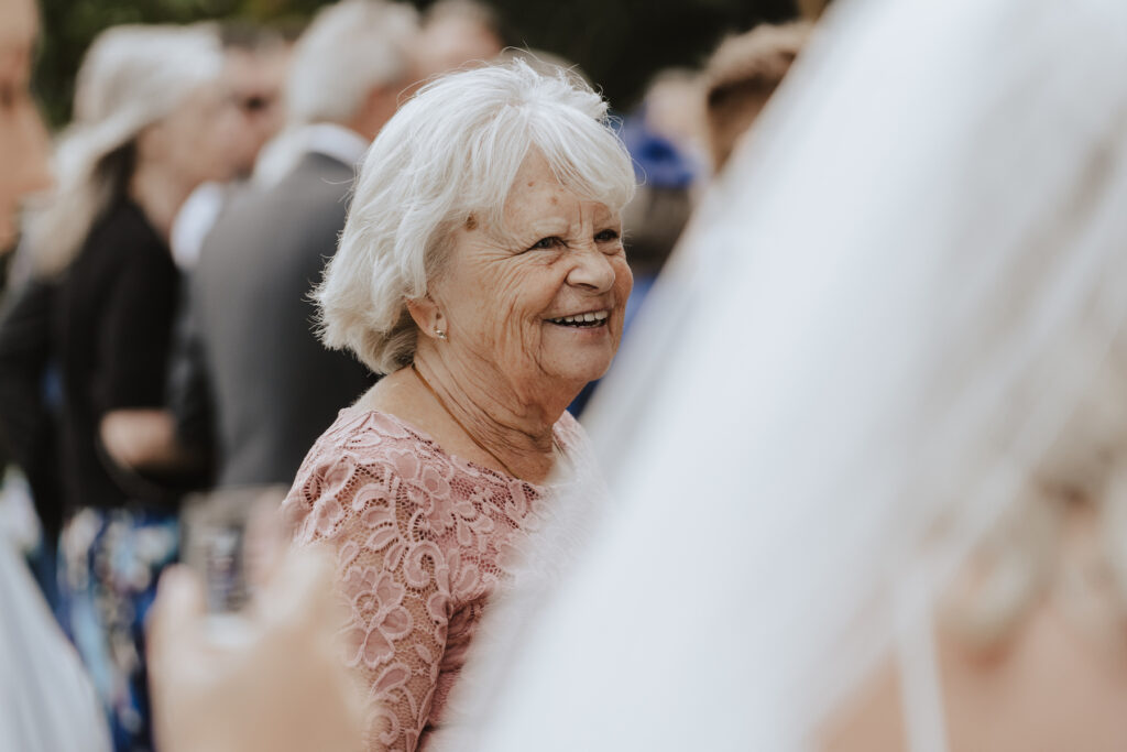 Candid wedding photography moments during the drinks reception at Butley Priory