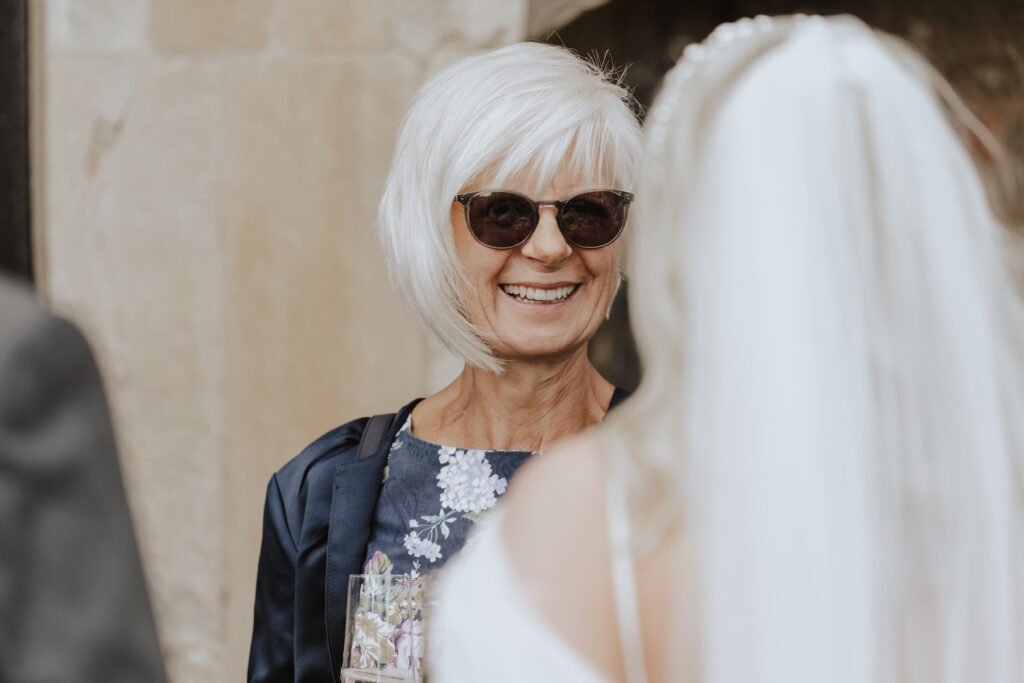 Suffolk wedding photographer capturing candid mom drinks reception at Butley Prioryents during t