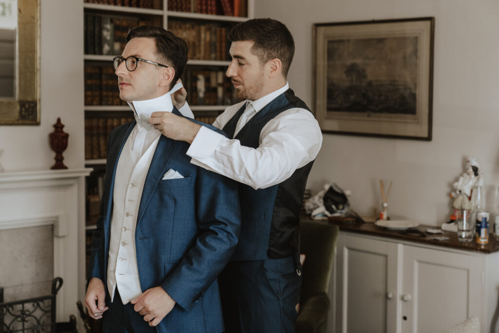 Capturing grooms prep in the farmhouse at Butley Priory