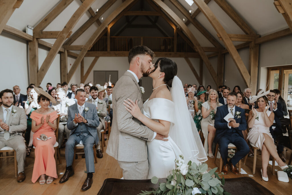 First kiss at the ceremony barn in Easton Grange