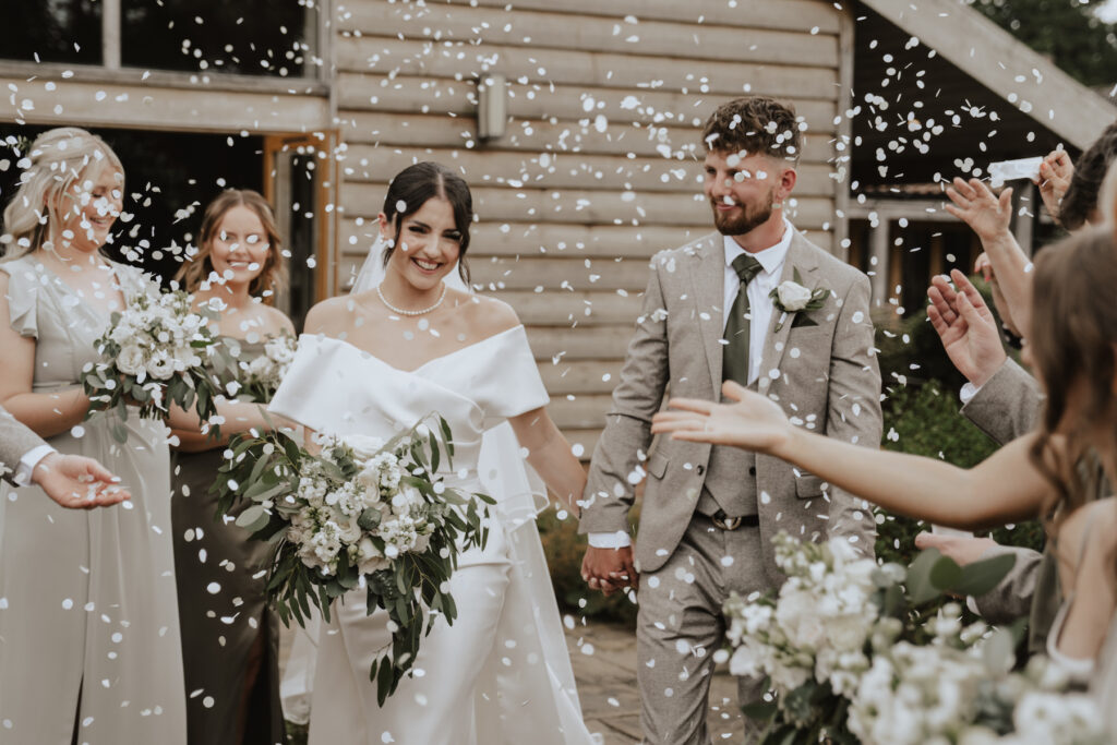 Confetti throwing outside the ceremony barn at Easton Grange