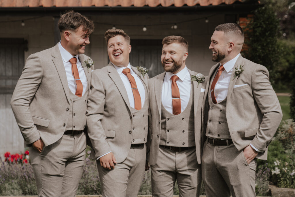 Suffolk wedding photographer capturing the groom with his groomsmen at The Granary Estates