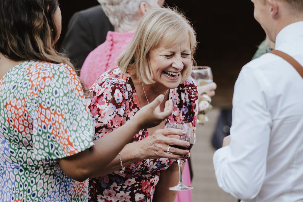 Outdoor candid photos of the guests during wedding drinks reception at Swallows Nest Barn