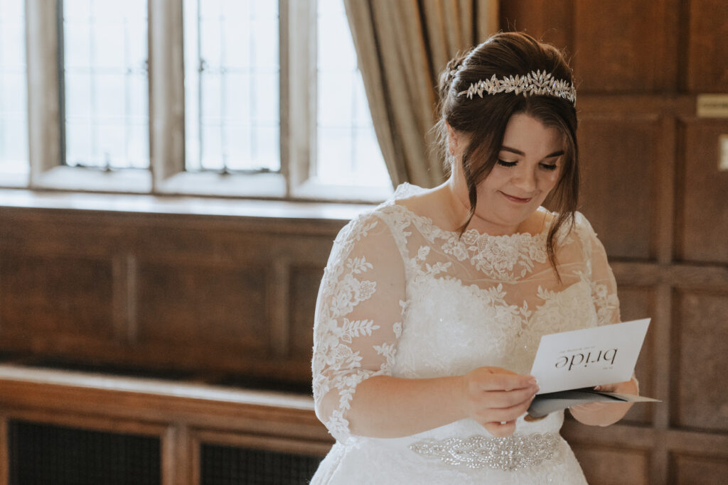 Suffolk wedding photographer capturing the bride reading a letter in the morning of her wedding at Hengrave Hall