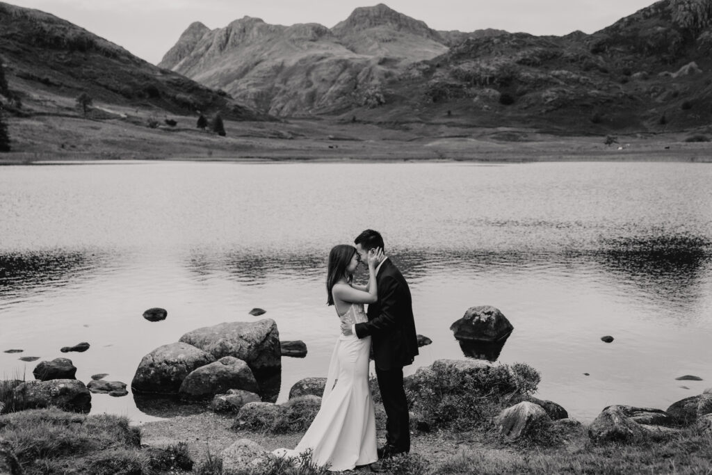 An eloping couple sharing their first kiss during their Lake District elopement