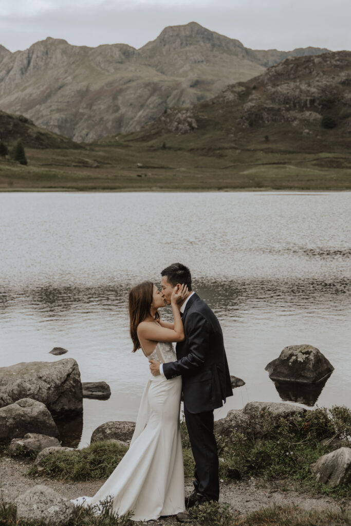 A couple eloping in the Lake District by the water
