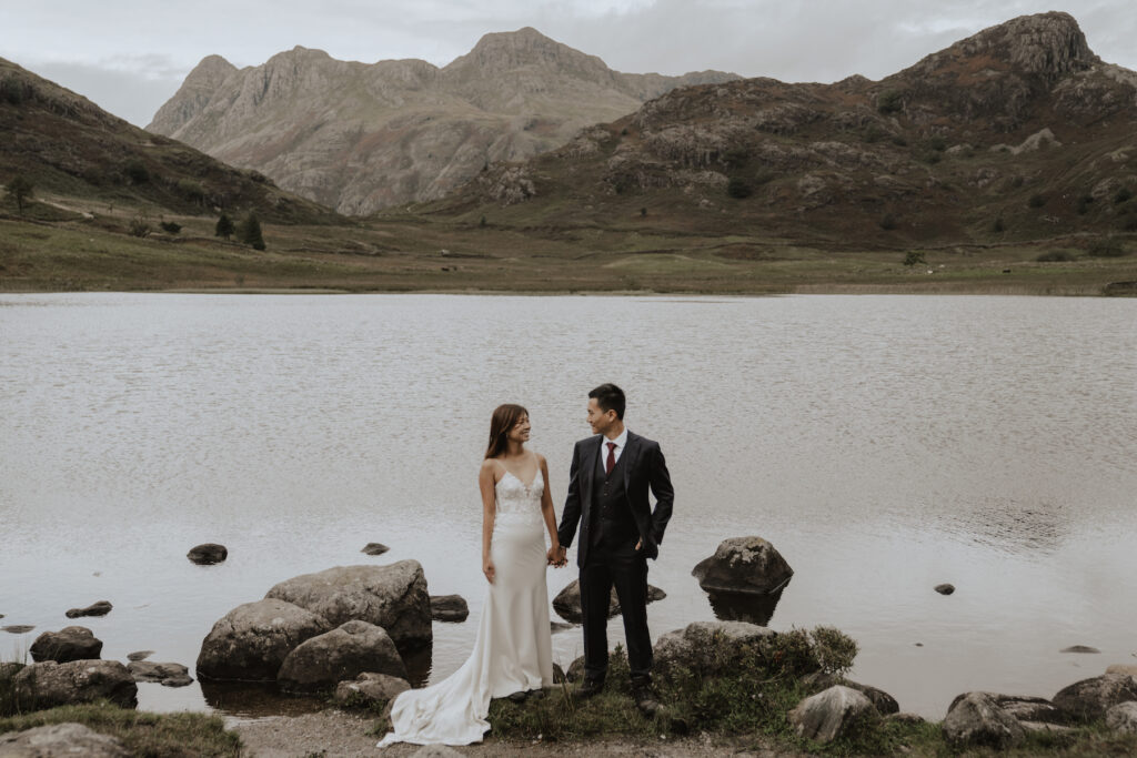 A couple eloping by a tarn in the Lake District