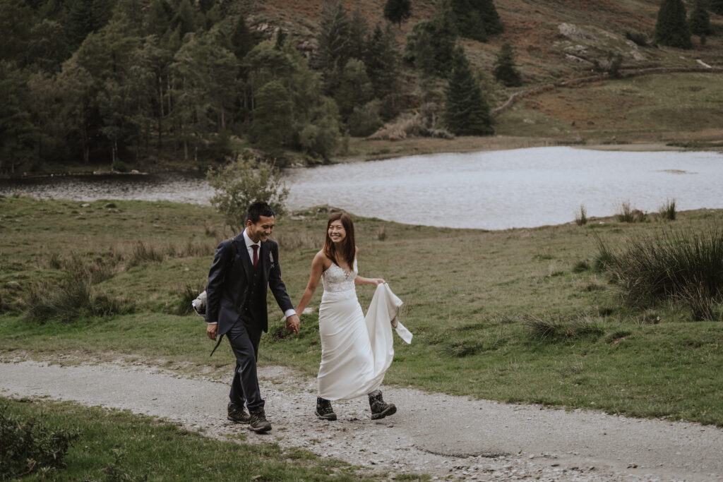An eloping couple in the Lake District hiking during their elopement