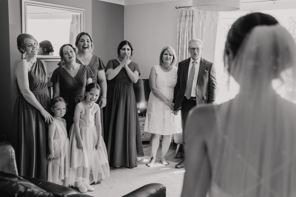 Midlands wedding photographer capturing the reaction of bridesmaids to the bride