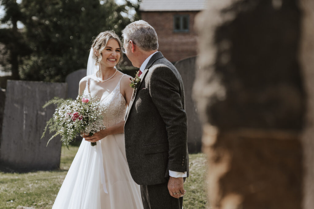 The bride and her father before walking into the church, captured by a midlands wedding photographer