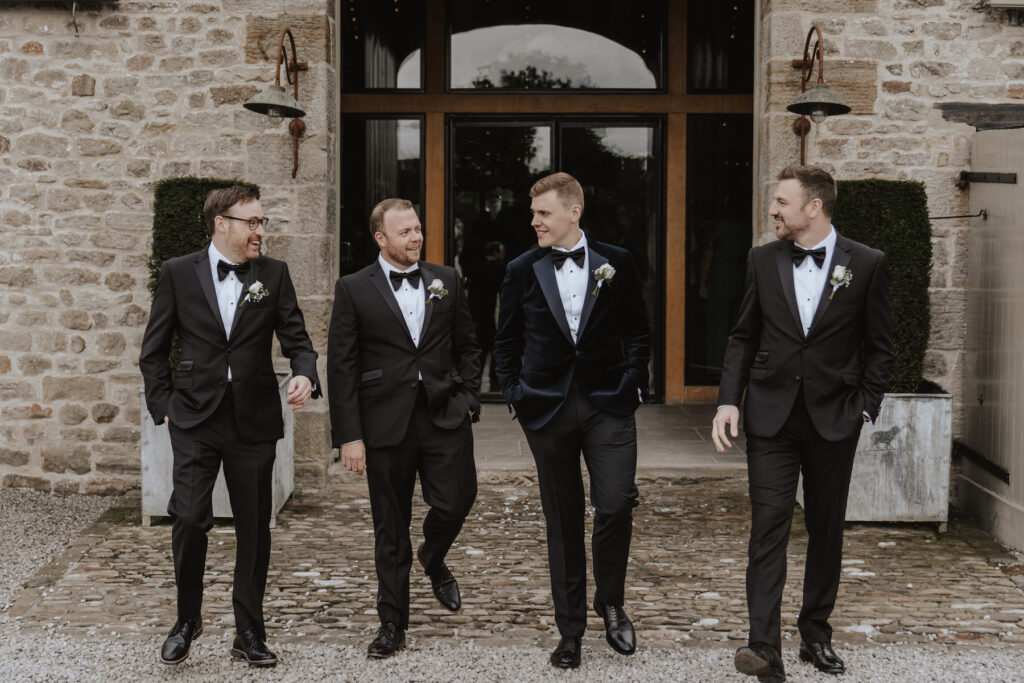 Wedding photographer in Yorkshire capturing a formal photo of the groomsmen at Tithe barn