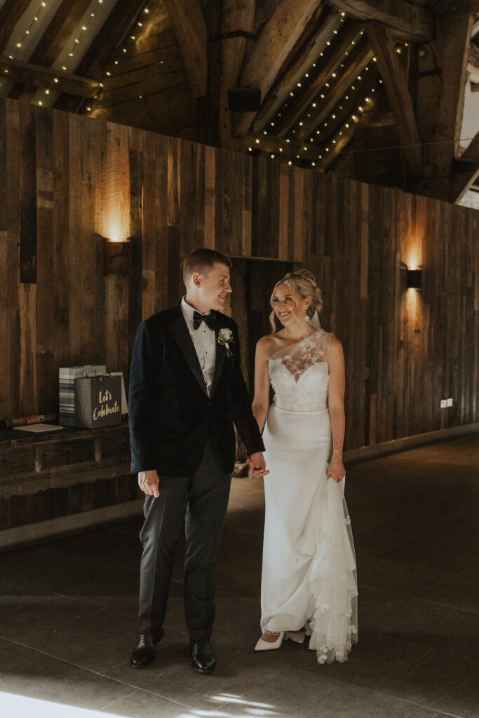 The couple stood together in the main barn at The Tithe Barn at Bolton Abbey