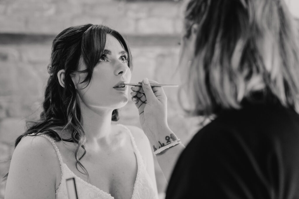 The bride getting her makeup completed on the morning on her wedding in the bridal suite at Crockwell Farm