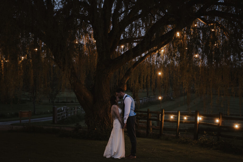 The couple in the courtyard at Crockwell Farm at night