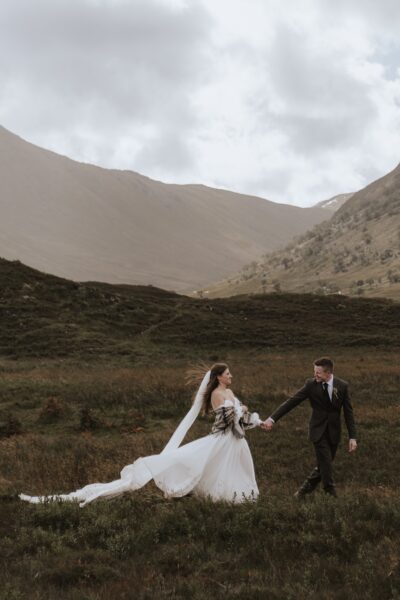 Eloping couple in the Scottish highlands during their wedding day