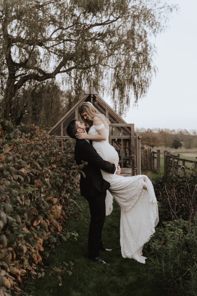 A married couple stood at Crockwell Farm having their wedding photos