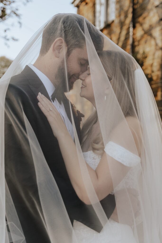 Veil photos of the couple during their wedding portraits at Crockwell Farm