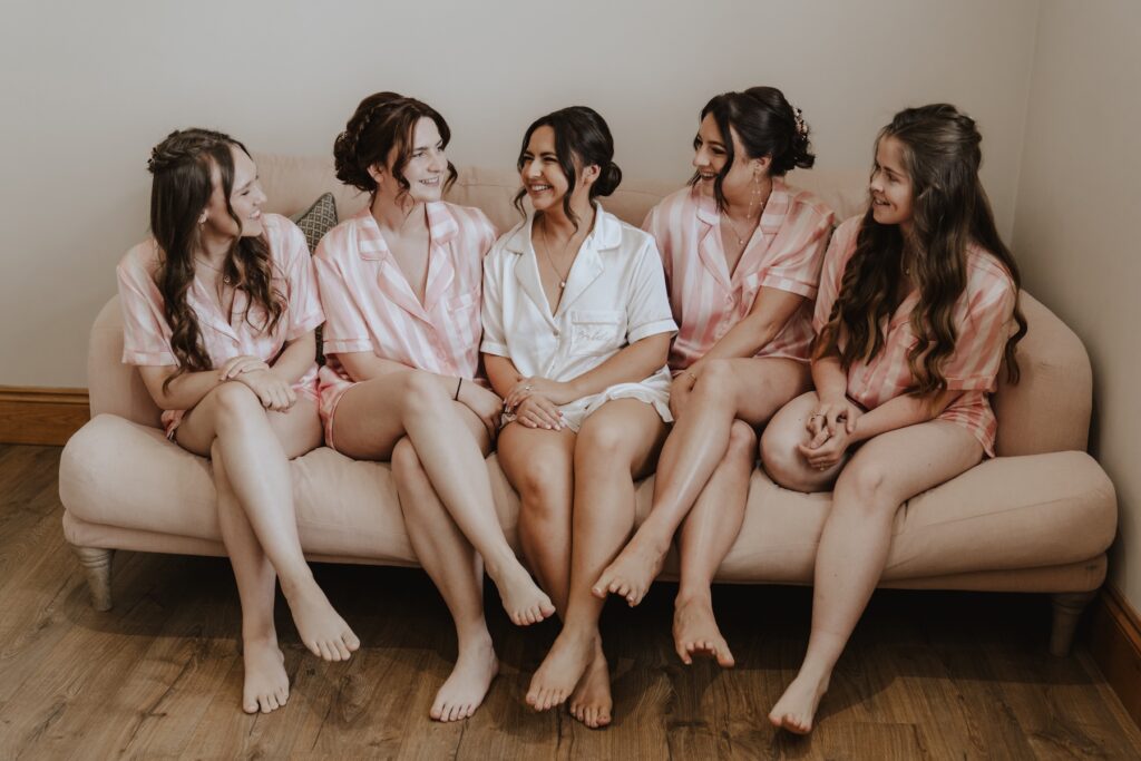 The bride and her bridesmaids at Maidens Barn in Essex
