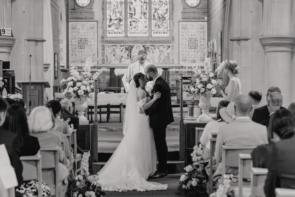 First kiss in the ceremony captured by an Essex wedding photographer