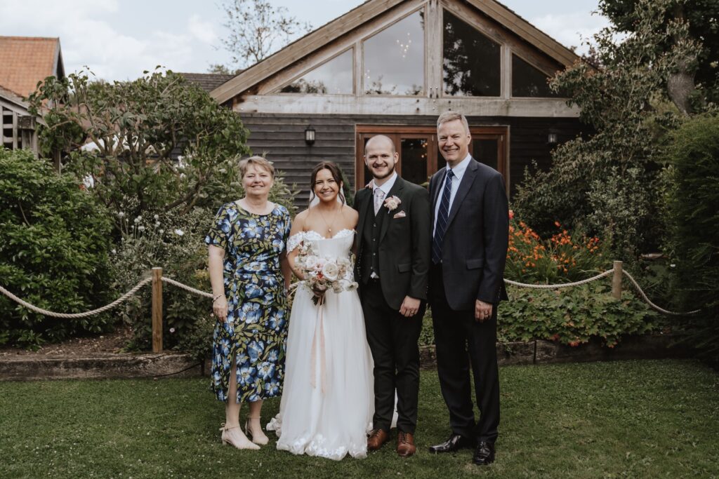 Essex wedding photographer capturing formal photos during drinks reception at Maidens Barn in Chelmsford