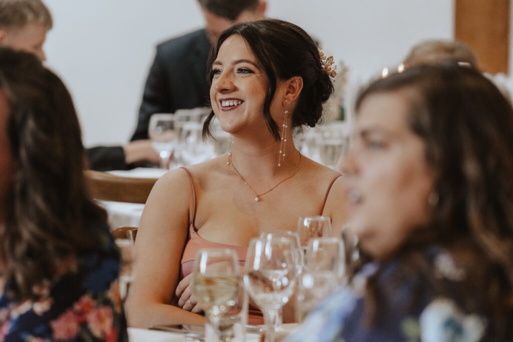 Essex wedding photographer capturing candids during speeches at Maidens Barn