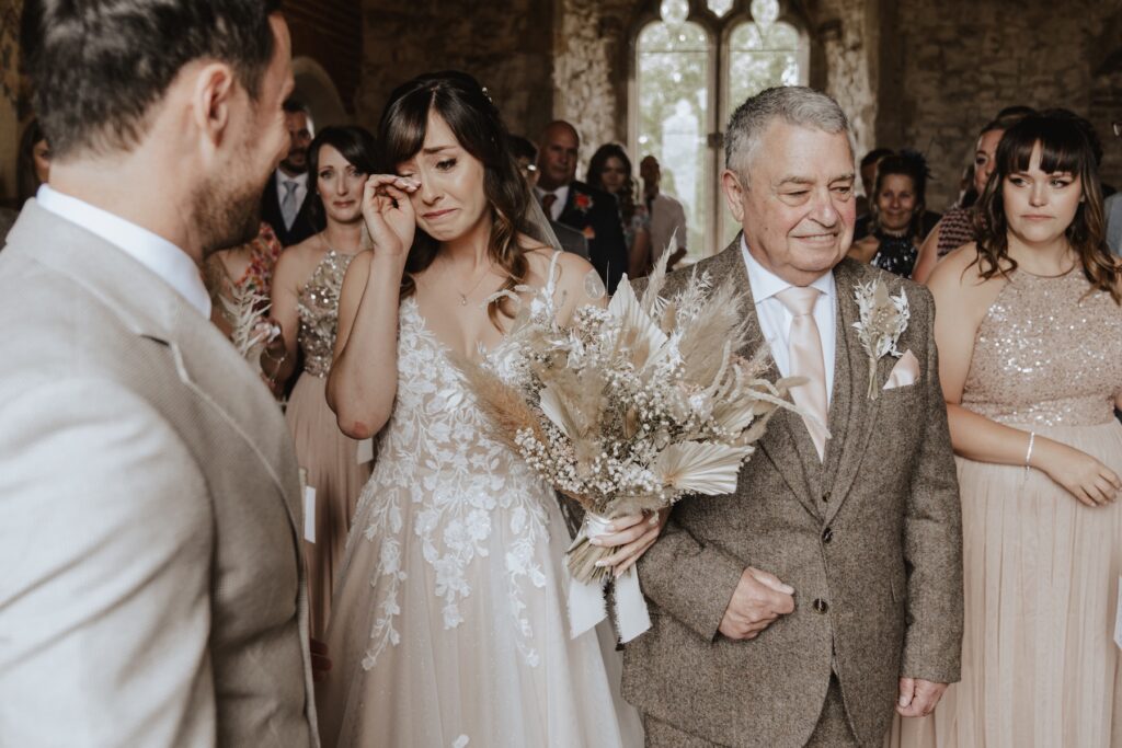 Norfolk wedding photographer capturing the bride walking down the aisle at Pentney Abbey