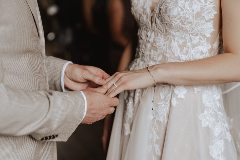 Norfolk wedding photographer capturing the ring exchange during the ceremony at Pentney Abbey