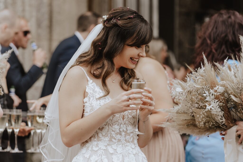 Norfolk wedding photographer capturing candids during the drinks reception at Pentney Abbey