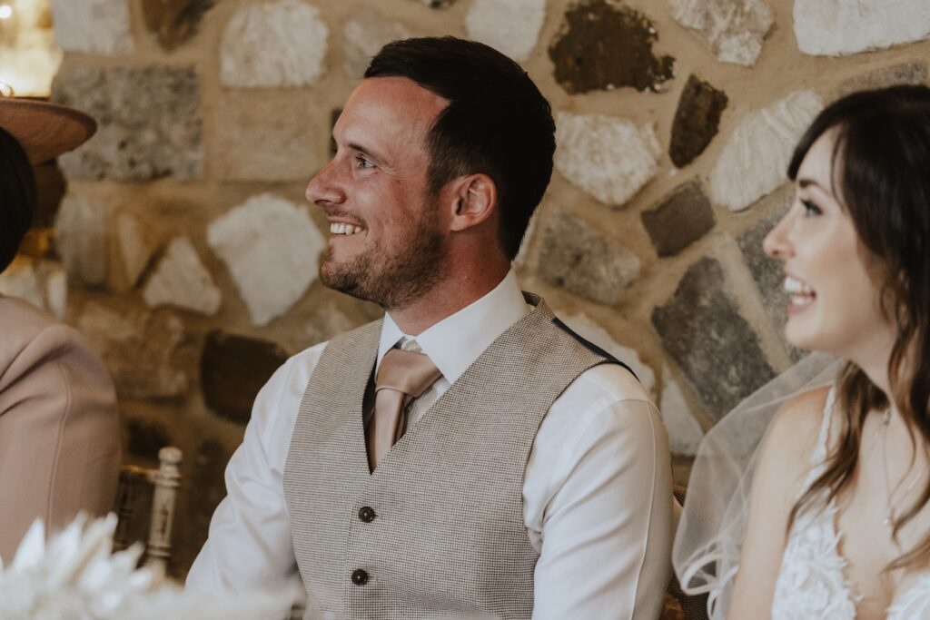 Norfolk wedding photographer capturing candids during speeches in Pentney Abbey