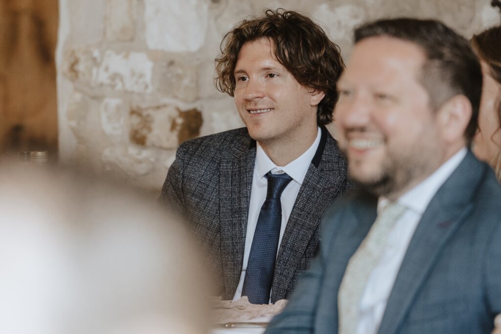 Norfolk wedding photographer capturing candids during speeches at Pentney Abbey
