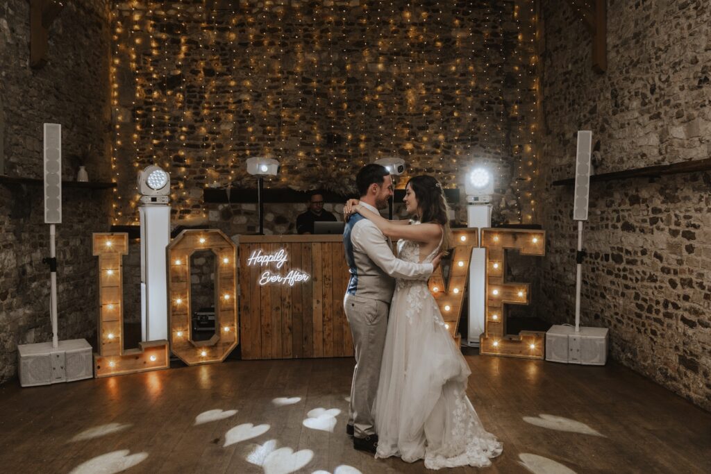 A newlywed couple in Norfolk having their first dance at Pentney Abbey