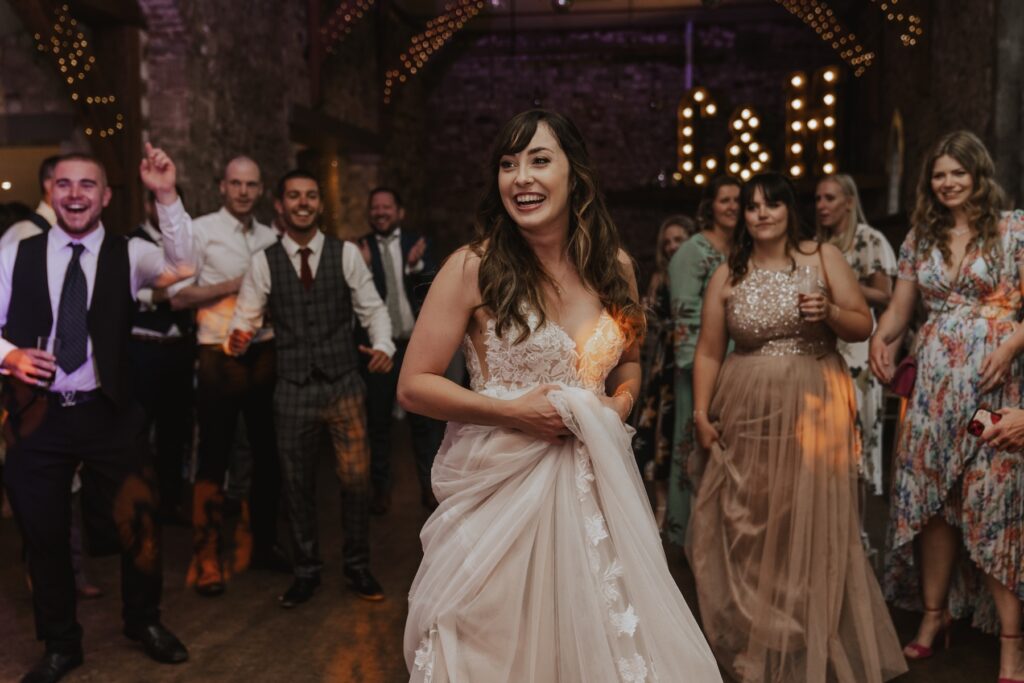 Norfolk wedding photographer capturing the bride on the dance floor at Pentney Abbey