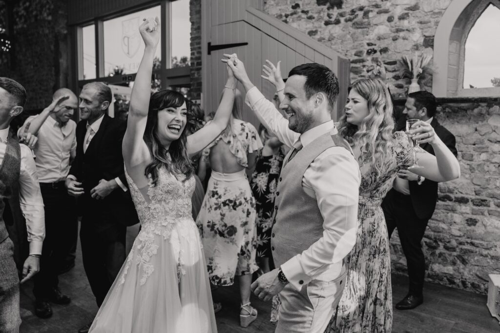 Wedding photographer in Norfolk capturing dance floor moments with the couple at Pentney Abbey in Norfolk