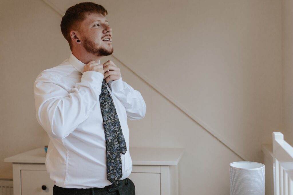 Scotland elopement photographer capturing grooms prep on the morning of the elopement