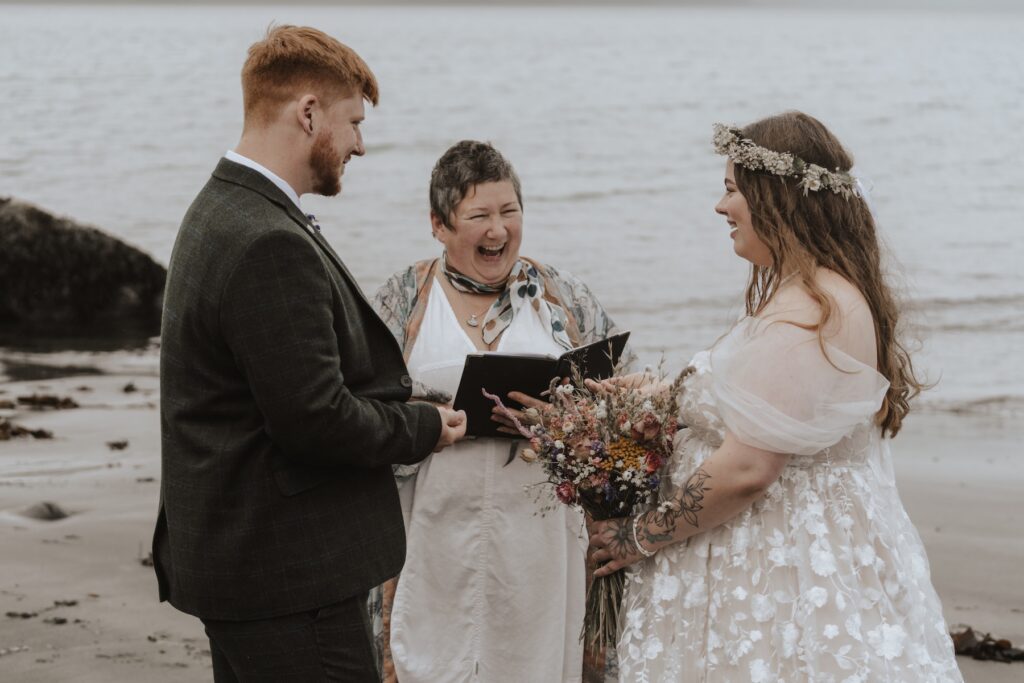 The couple having their elopement ceremony on An Corran Beach on the Isle of Skye in Scotland