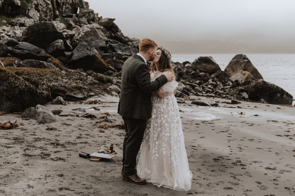 Scotland elopement photographer capturing the first kiss of an eloping couple on the Isle of Skye