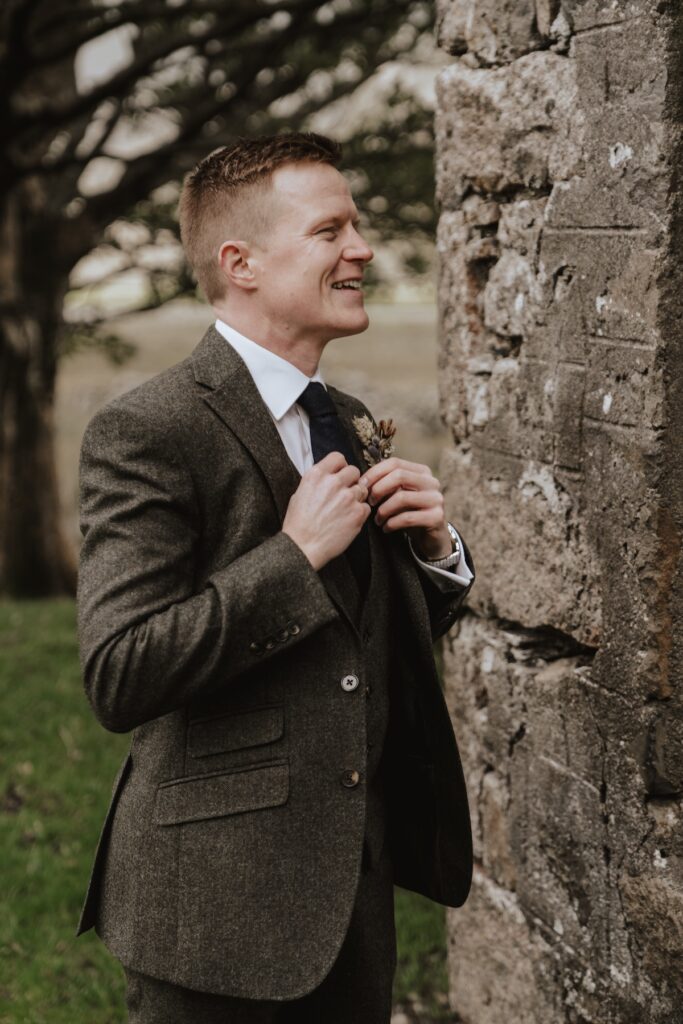 Grooms prep during the morning of Sasha and Matt's Scotland elopement