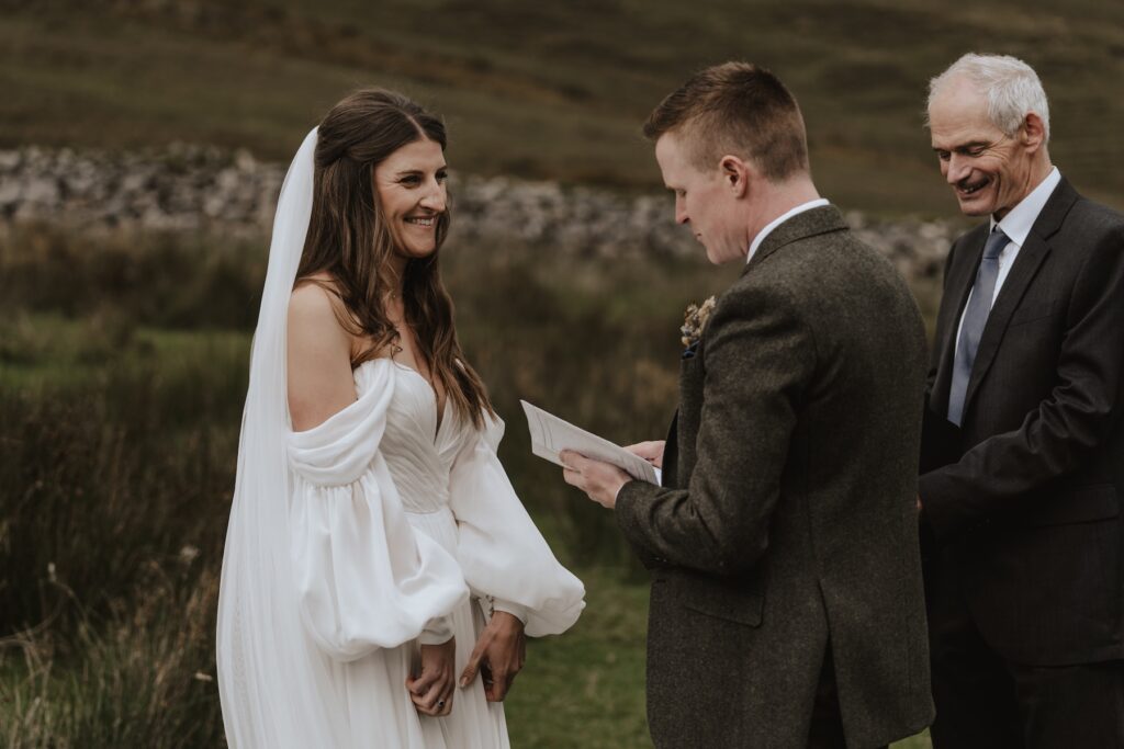 The couple sharing vows during their elopement ceremony in Scotland