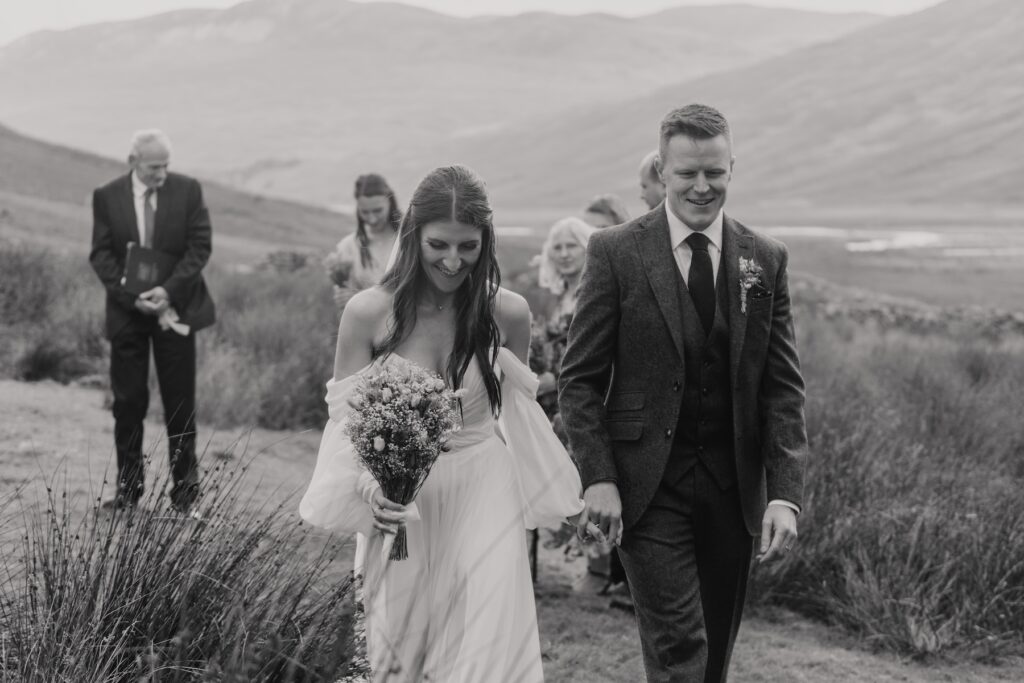 The couple walking down the aisle after their elopement ceremony in Scotland