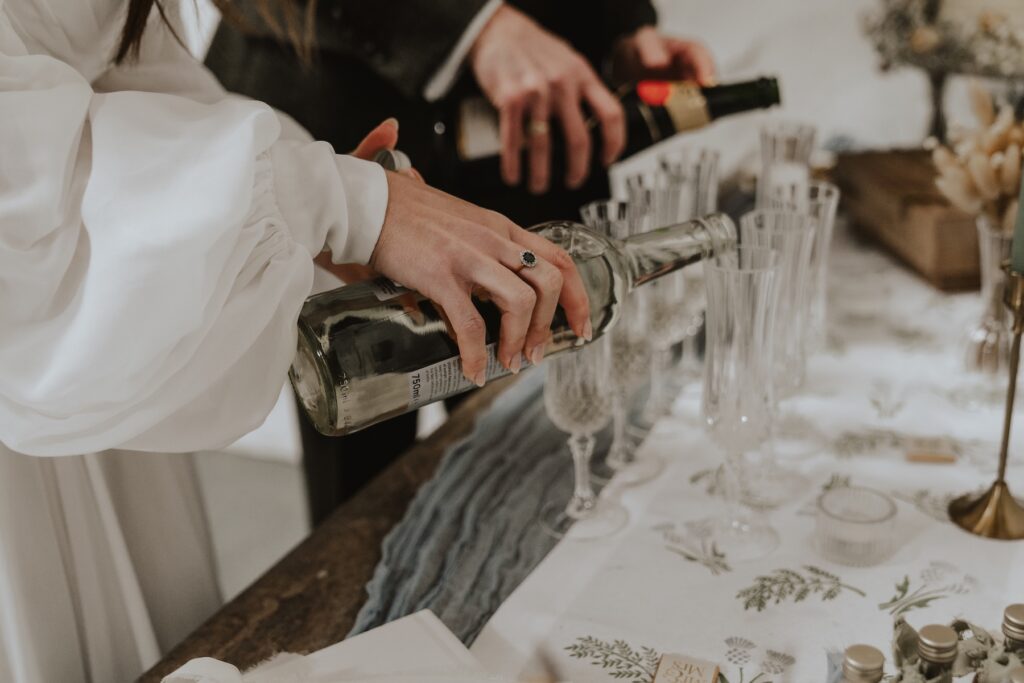 Pouring drinks to celebrate a Scotland elopement