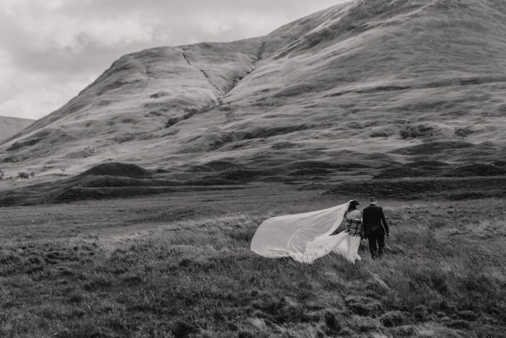 Scotland elopement photographer capturing portraits of the couple as they explore landscape on their elopement