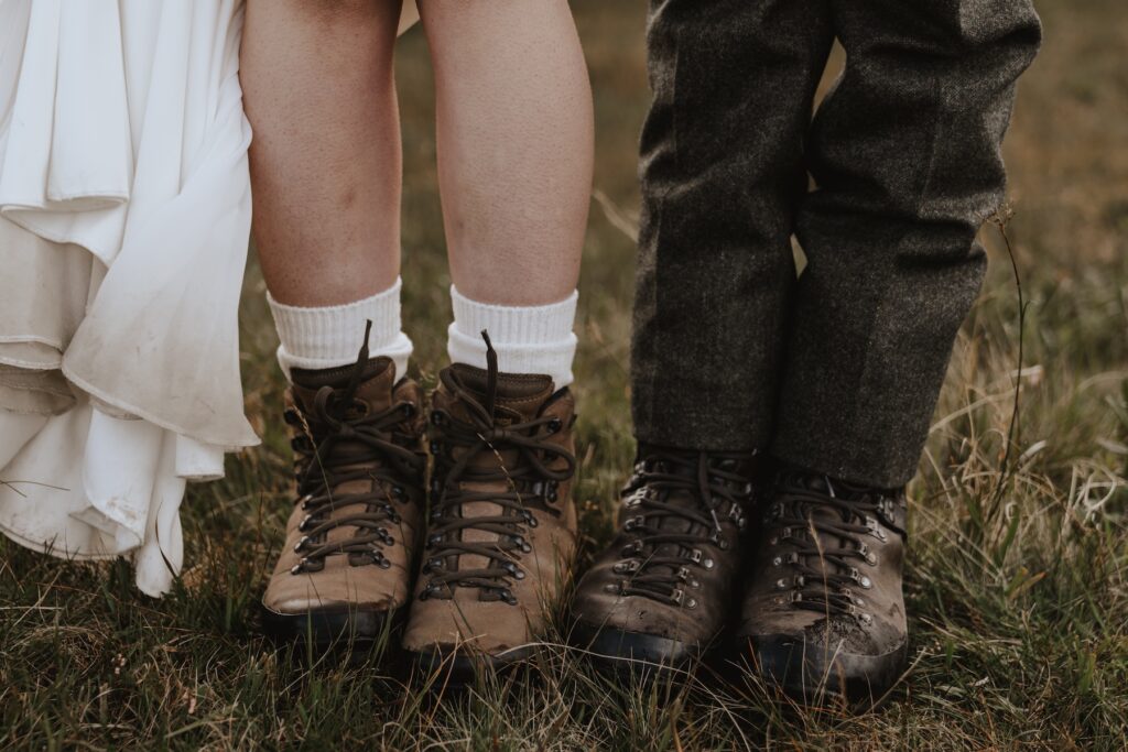 The couple wearing hiking boots on their Scotland elopement