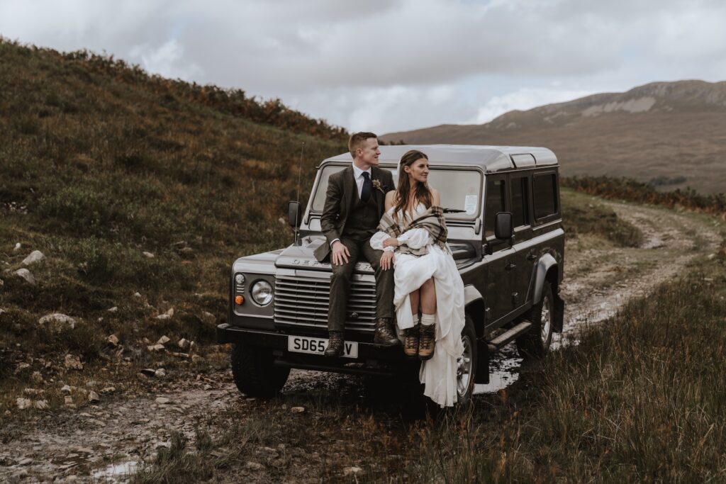 A couple with their 4x4 during their adventurous Scotland elopement