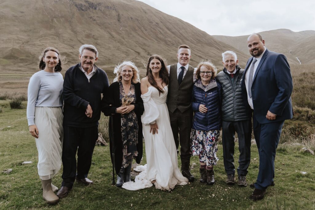 A group photo on a Scotland elopement with their guests