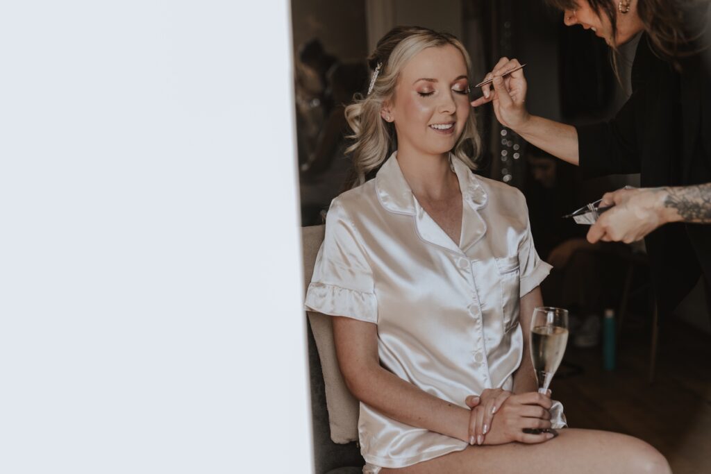 Northamptonshire wedding photographer capturing the bride getting ready in the bridal suite at Swallows Nest Barn